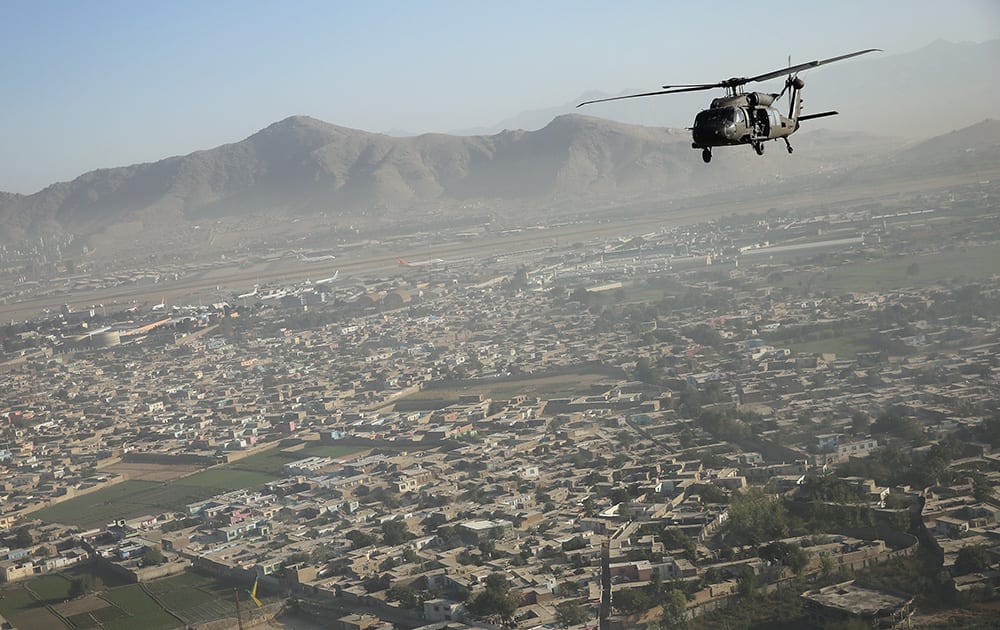 A Black Hawk flies over the city, during Britain's Prime Minister David Cameron visit, in Kabul, Afghanistan.