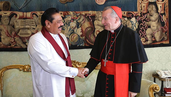 Sri Lankan president Mahinda Rajapaksa, left, shakes hands with Vatican Secretary of State Pietro Parolin after meeting with Pope Francis on the occasion of their private audience, at the Vatican.