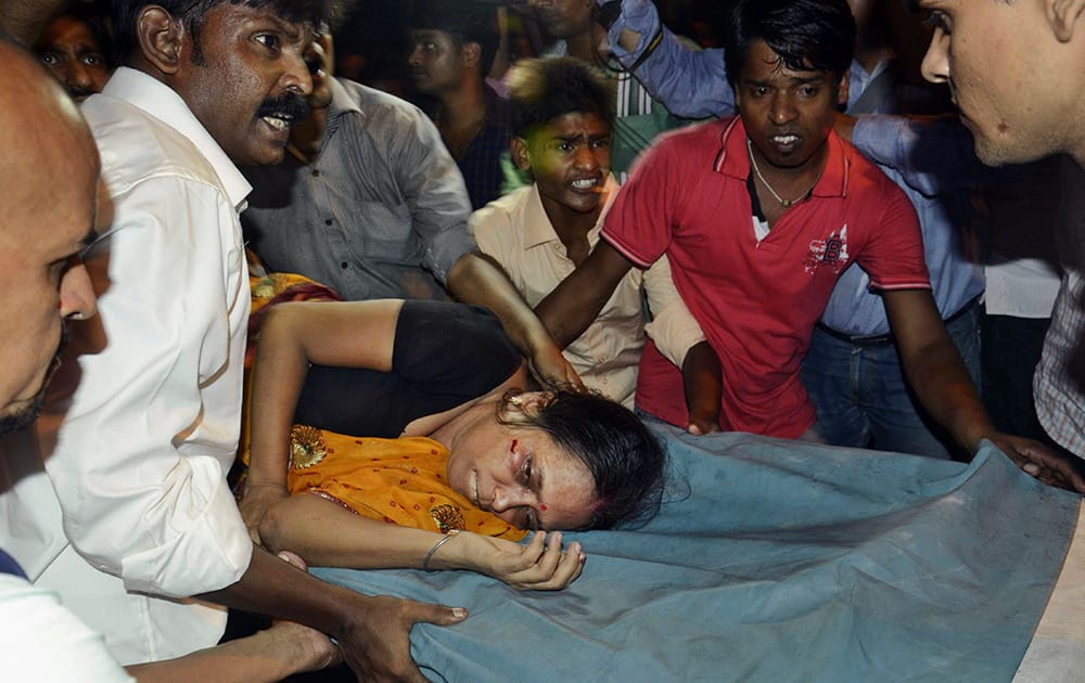 An Injured woman is carried on a stretcher to a hospital for treatment in Patna.