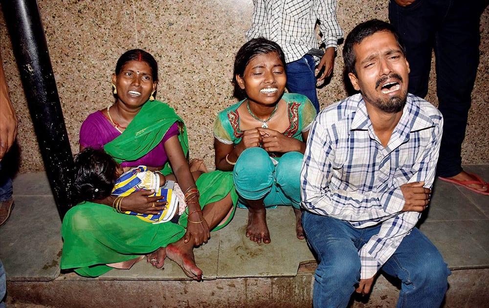 Family members of injured victims weep outside a hospital after a stampede occured during Dussehra function at Gandhi Maidan in Patna.