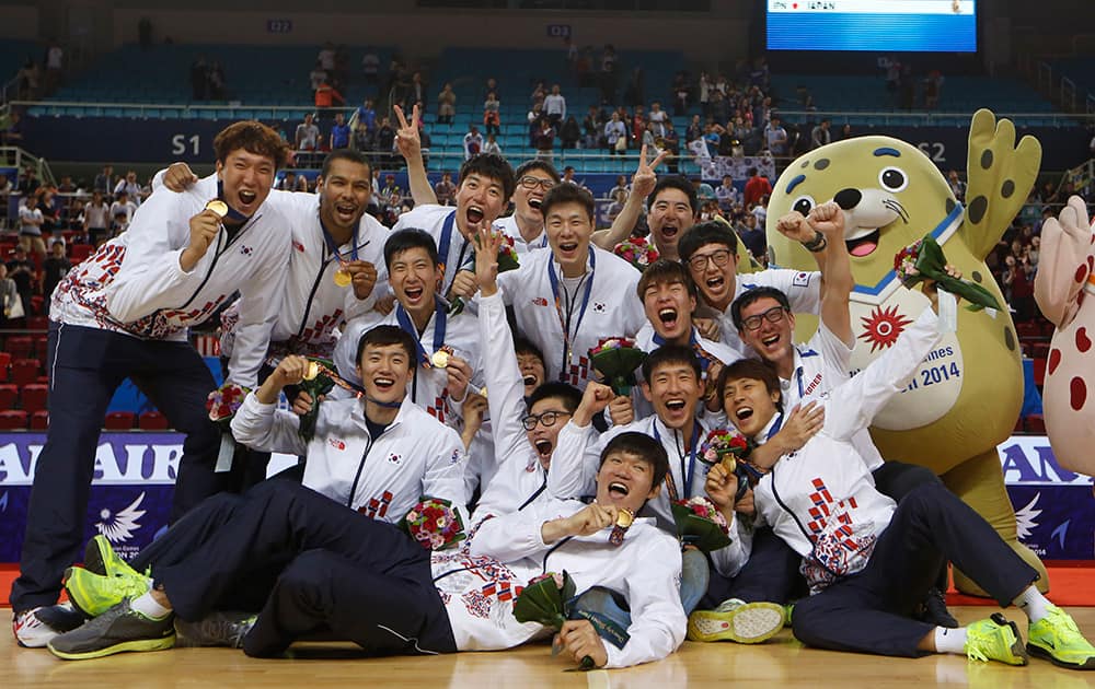 Gold medal winner South Korea team celebrate after winning the men's basketball match against Iran at the 17th Asian Games in Incheon, South Korea.