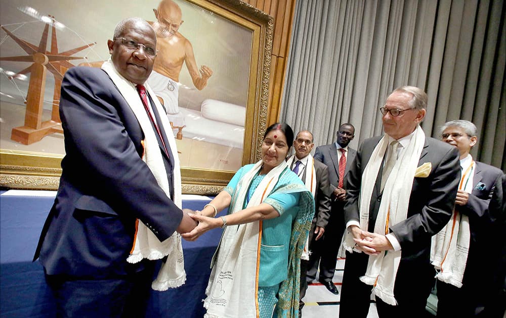 Sam Kutesa, President of the 69th UNGA and External Affairs Minister Sushma Swaraj at the unveiling of a painting of Mahatma Gandhi during the celebration of the International Day of Non-Violence at the United Nations in New York.