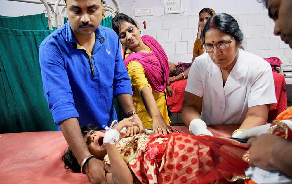 A injured girl receives treatment in a hospital after a stampede during a Dussehra function at Patnas Gandhi Maidan on Friday night.