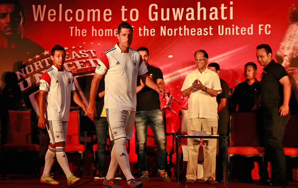 Spain's Joan Capdevila, foreground, walks the ramp with other members of NorthEast United Football Club of Hero Indian Super League 2014 (ISL) during the launch of the team's jersey, in Guwahati.
