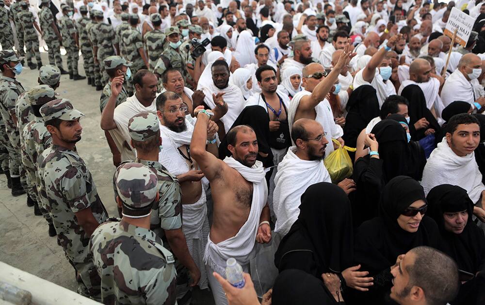 Muslim pilgrims cast stones at a pillar in a ritual called 'Jamarat,' symbolizing the stoning of Satan, the last rite of the annual hajj, in the Mina neighborhood of Mecca, Saudi Arabia.