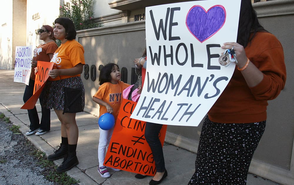 People protest in front of the Whole Women's Health clinic in McAllen, Texas. Abortion-rights lawyers are predicting 'a showdown' at the U.S. Supreme Court after federal appellate judges allowed full implementation of a law that has closed more than 80 percent of Texas' abortion clinics.