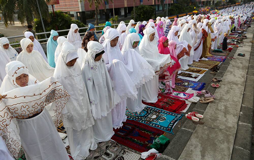 Muslims attend a morning prayer marking the Eid al-Adha holiday on a street in Jakarta, Indonesia.