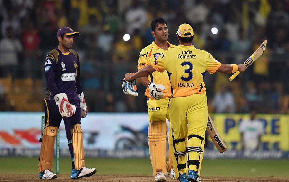 Chennai Super Kings batsman M S Dhoni and Suresh Raina celebrates the win during the CLT20 final match against Kolkata Knight Riders at Chinnaswamy Stadium in Bengaluru.