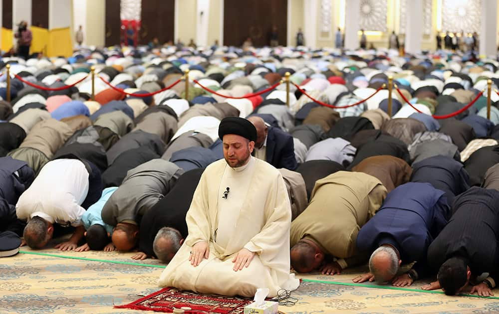 Ammar al-Hakim, leader of Iraq's largest Shiite party, the Supreme Islamic Iraqi Council, prays during Eid al-Adha or Feast of Sacrifice prayer, inside the party headquarters, in Baghdad, Iraq.