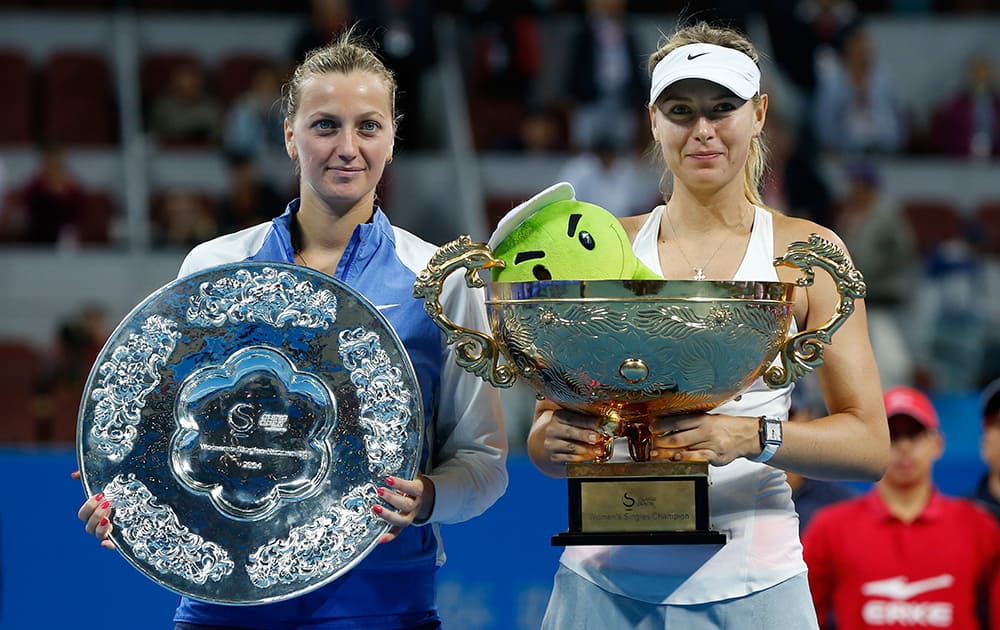 Maria Sharapova of Russia, and Petra Kvitova of the Czech Republic pose for photos after Sharapova won the women's single final at China Open tennis tournament at the National Tennis Stadium in Beijing, China.