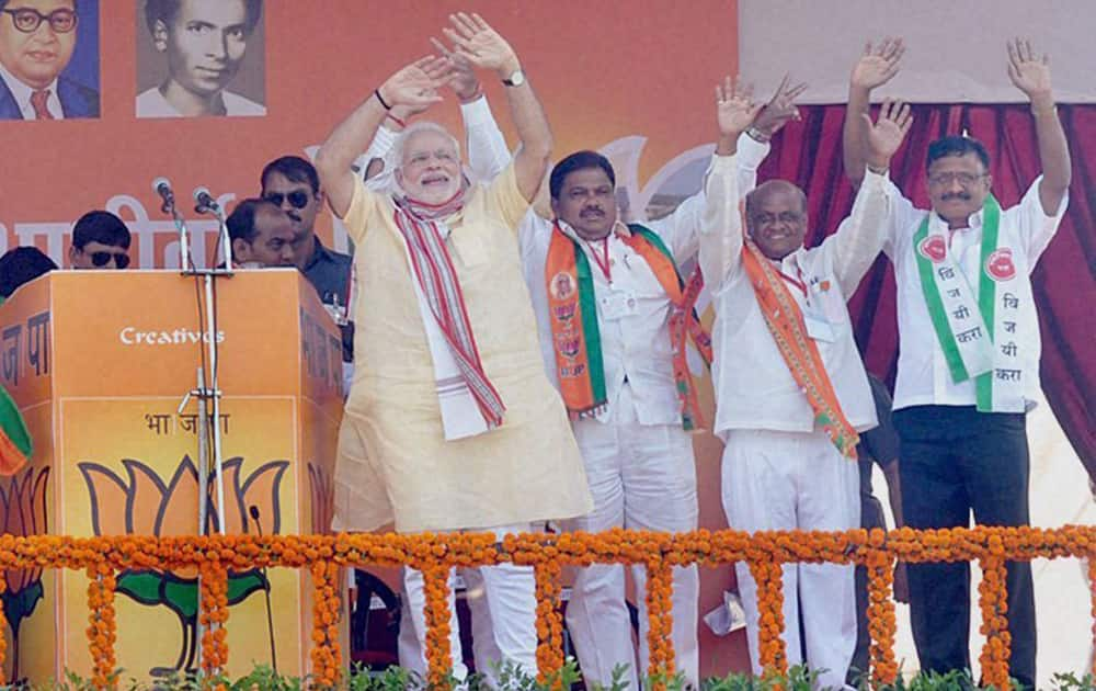 Prime Minister Narendra Modi along with other leaders during an election campaign rally ahead of the upcoming Maharashtra assembly elections in Kolhapur.