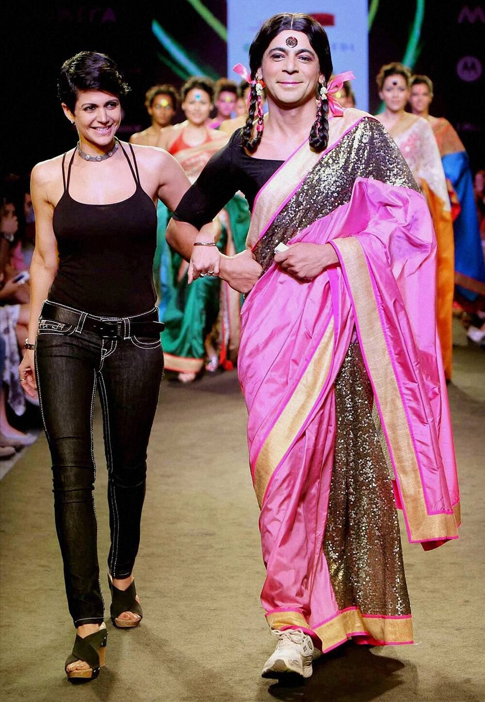 Actor Sunil Grover dressed as his famous character Guthhi walks the ramp with actresss Mandira Bedi during a Fashion show in Mumbai.