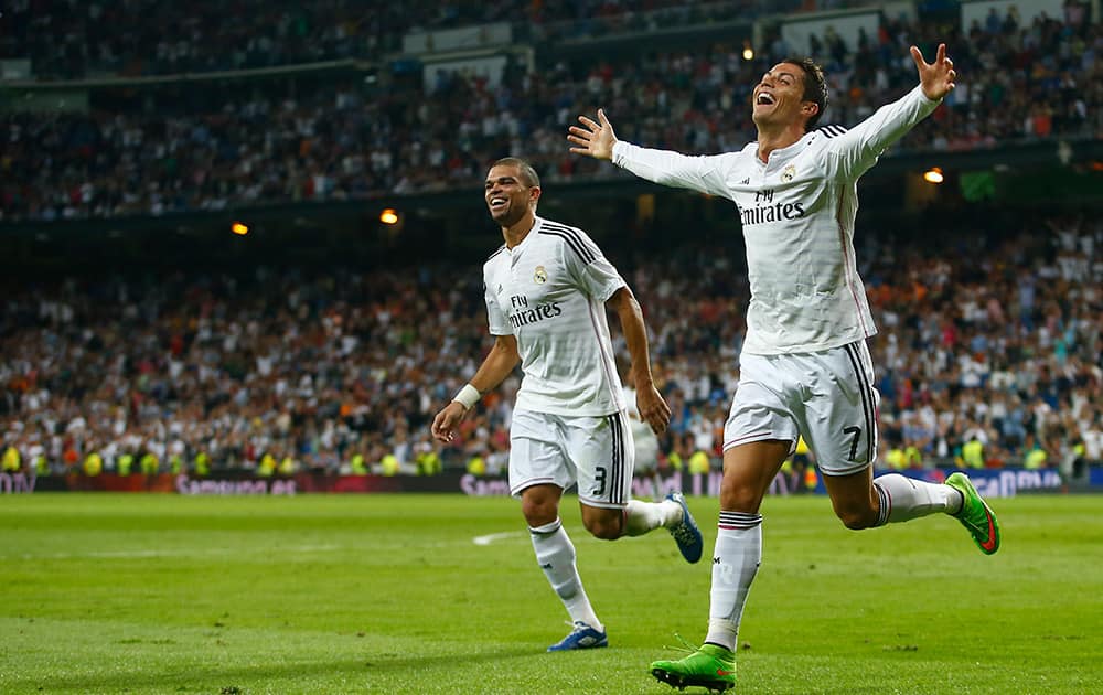 Real's Cristiano Ronaldo, celebrates his third goal with Pepe, during a Spanish La Liga soccer match between Real Madrid and Athletic Bilbao at the Santiago Bernabeu stadium in Madrid, Spain.