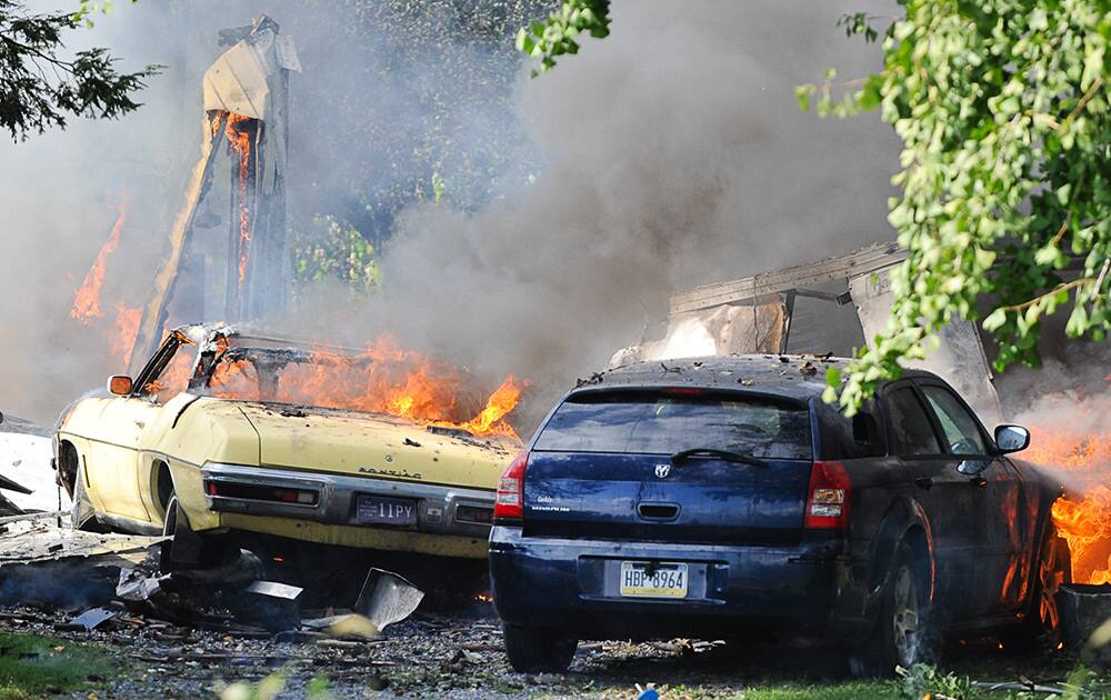 Firefighters tend to a blaze following an explosion that destroyed the building and set neighboring corn fields, near Maytown, Pa.