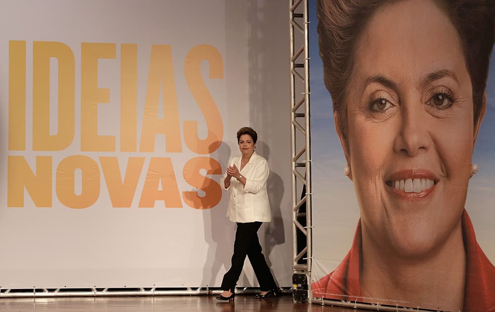 Brazil's President Dilma Rousseff, presidential candidate for re-election of the Workers Party, PT, arrives to attends a press conference, in Brasilia, Brazil.