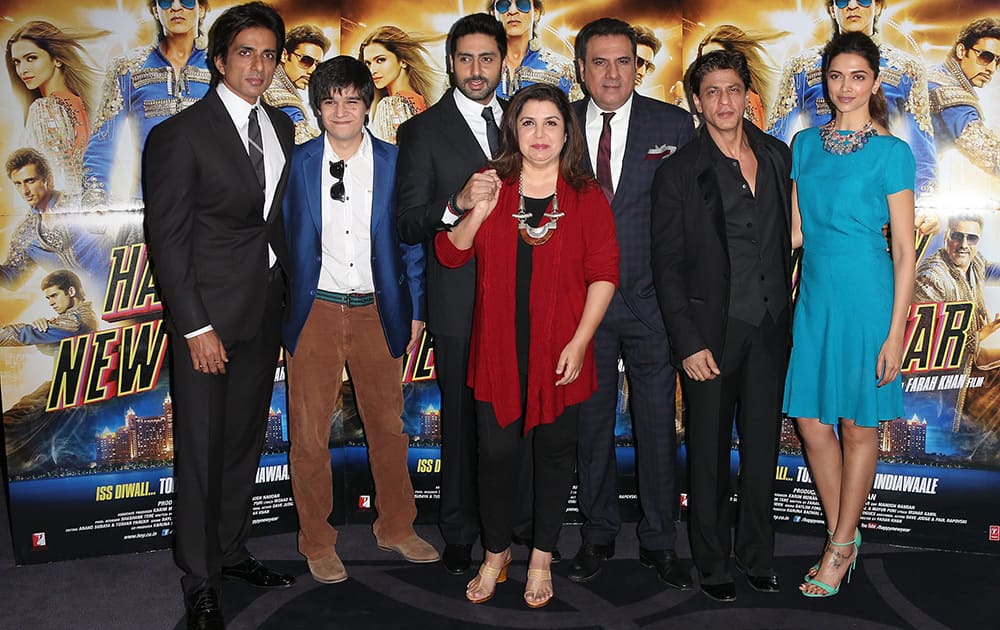 Director Farah Khan, poses for photographers with actors, Sonu Sood, Vivaan Shah, Abhishek Bachchan, Boman Irani, Shah Rukh Khan and Deepika Padukone, during a photo call for the film, Happy New Year-SLAM, at the Montcalm hotel in central London.