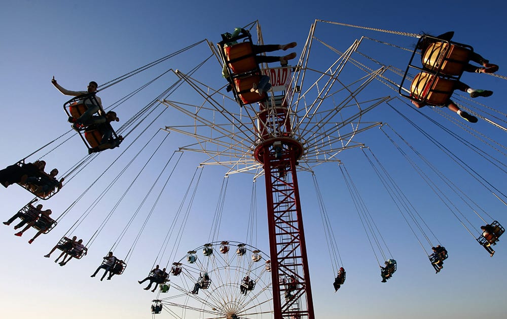 Palestinians enjoy a ride in an amusement park during Eid al-Adha, a holiday celebrated by Muslims worldwide, in the West Bank city of Jenin.