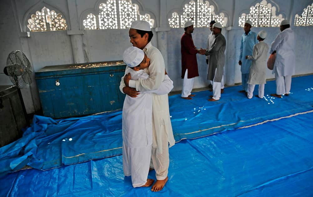 Muslims greet each other after offering prayers during Eid al-Adha, or the Feast of the Sacrifice, inside the Vasi Ullah mosque in Allahabad.