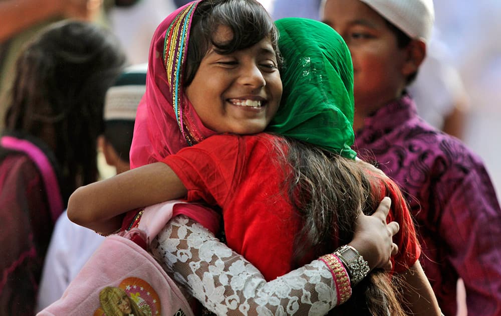 Muslim devotees hug each other after offering prayers on Eid al-Adha in Kolkata.