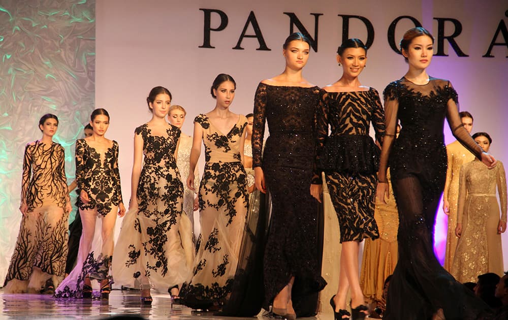 Models present creations during 'PANDORA House of Haute Couture' fashion show in Yangon, Myanmar. 