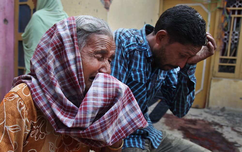 Relatives of Rajesh Kumar, who was killed in mortar shell firing allegedly from the Pakistan's side, weep inside their residential house at Masha da kothe village, in Arnia Sector near the India-Pakistan international border, about 47 kilometers (30 miles) from Jammu.