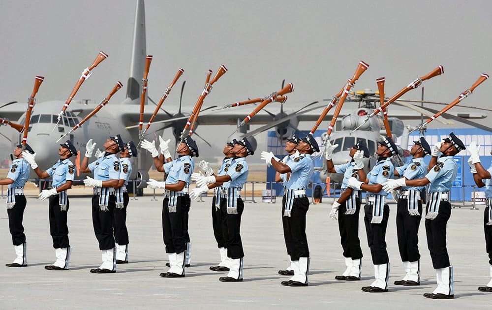 Air Force personnel perform with guns during the full dress rehearsal for the Air Force Day Parade, at Air Force Station Hindon in Ghaziabad.