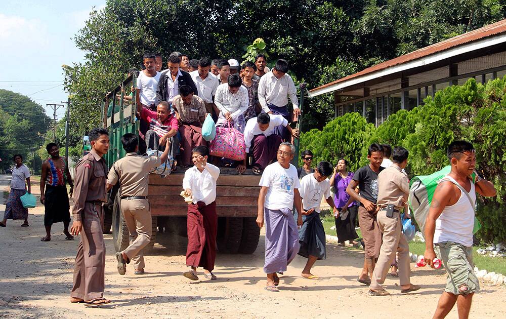 Myanmar's prisoners get off from a truck as they were released from Insein prison, in Yangon, Myanmar. The Myanmar government pardoned 3,073 prisoners on Tuesday, but advocacy groups said no political prisoners were included despite a pledge by President Thein Sein to free all such detainees by the end of this year.