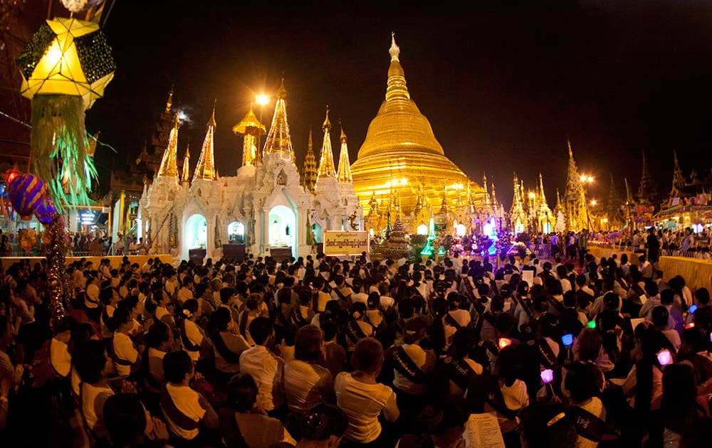 Buddhist devotees pray at Myanmar's landmark Shwedagon Pagoda during the eve of the full moon day of Thadingyut, the lighting festival to mark the end of Buddhist Lent, in Yangon, Myanmar..