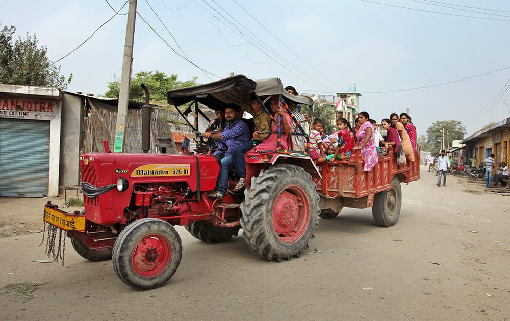 Indian villagers sit in a tractor as they leave their homes for a safer place for fear of firing from Pakistan side of the border in Arnia Sector near the India-Pakistan international border.