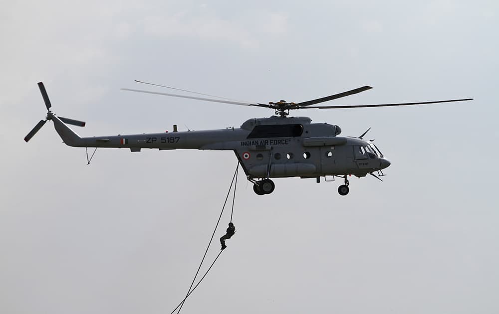 An Indian Air Force (IAF) commando demonstrates slithering skills as part of an aircrafts static display held ahead of Air Force Day celebrations at Jamnagar.