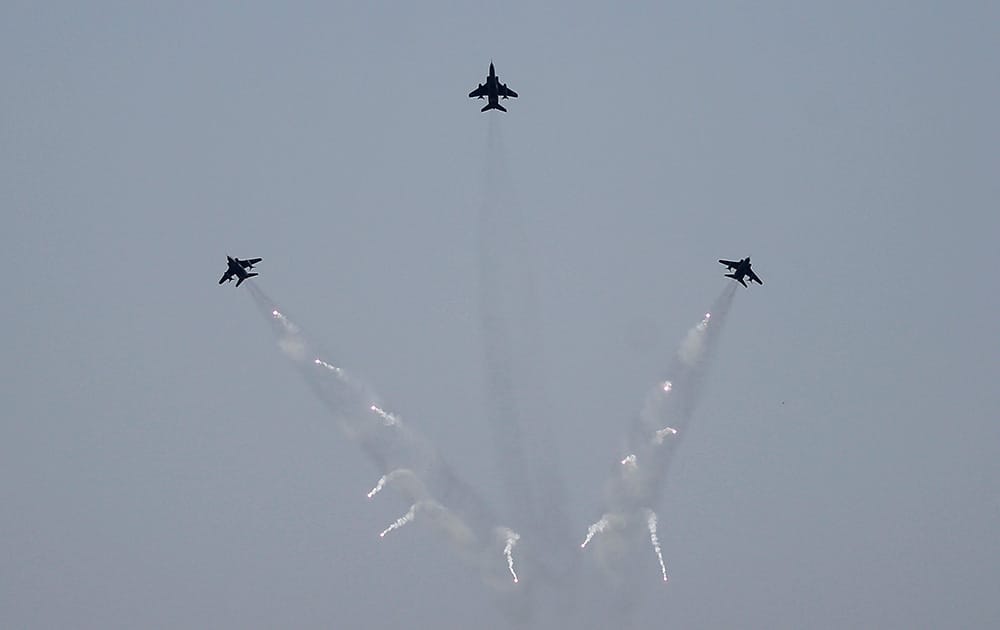 Indian Air Force (IAF) Jaguar jets release flares while performing a display during Air Force Day at the air force station in Hindon near New Delhi.