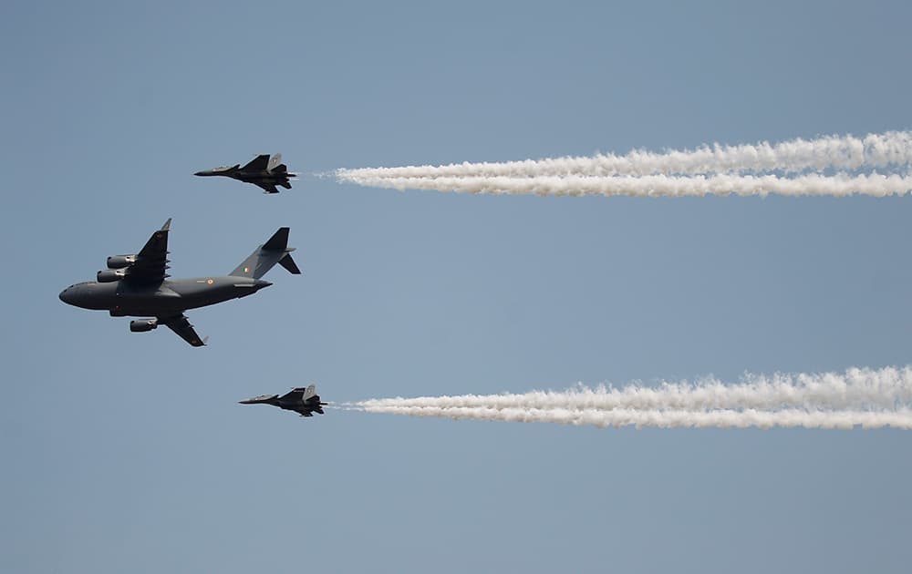 Indian Air Force's C-17 Globemaster III, center, with Sukhoi Su-30MKI flies in formation whiles displaying aerial demonstration during Air Force Day at the air force station in Hindon near New Delhi.