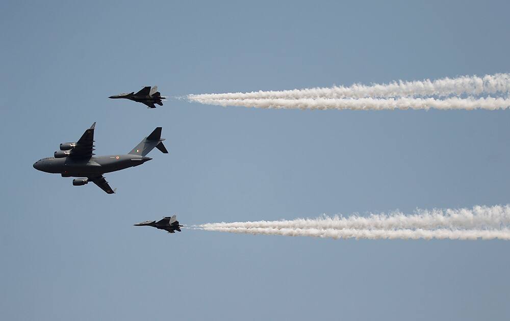 Indian Air Force's C-17 Globemaster III, center, with Sukhoi Su-30MKI flies in formation whiles displaying aerial demonstration during Air Force Day at the air force station in Hindon near New Delhi.