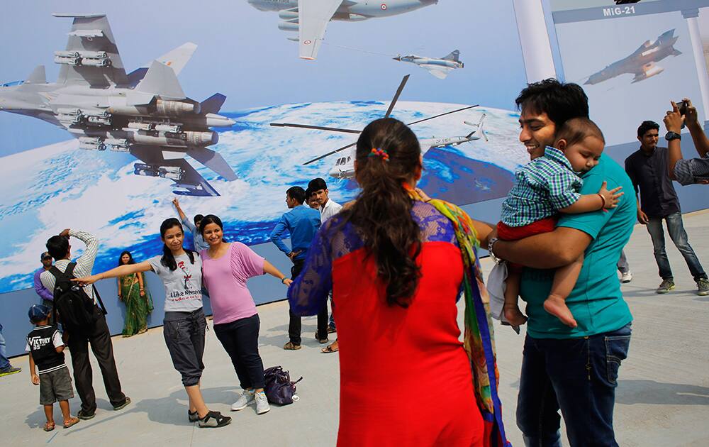 Indian visitors take pictures in front of the Indian Air Force (IAF) billboard during Air Force Day at air force station in Hindon near New Delhi.