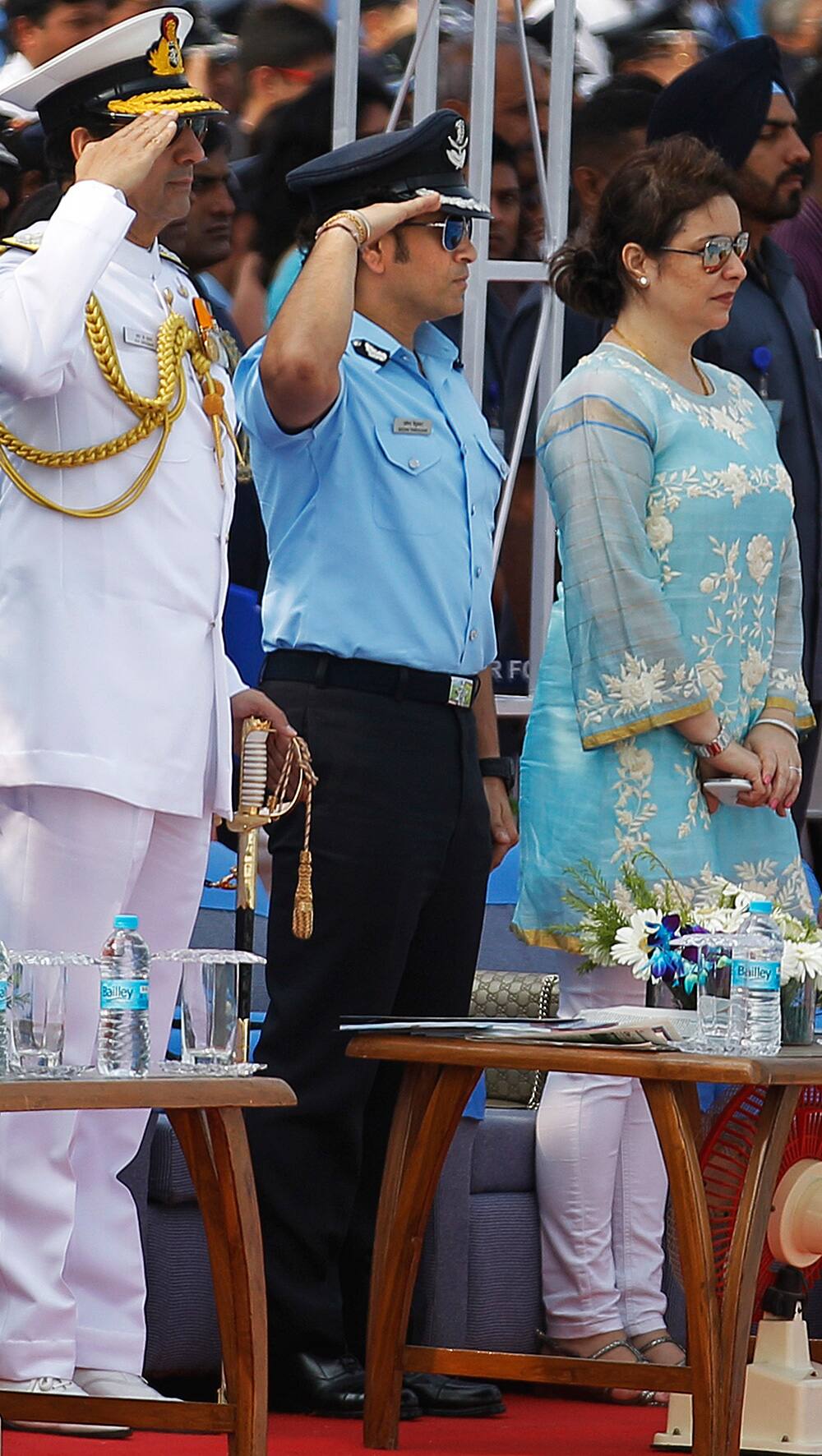 Former Indian cricketer and honorary Indian Air Force Group Captain Sachin Tendulkar, center, salutes along with other officers as Indian Air Force (IAF) personnel march during Air Force Day parade at the air force station in Hindon near New Delhi.