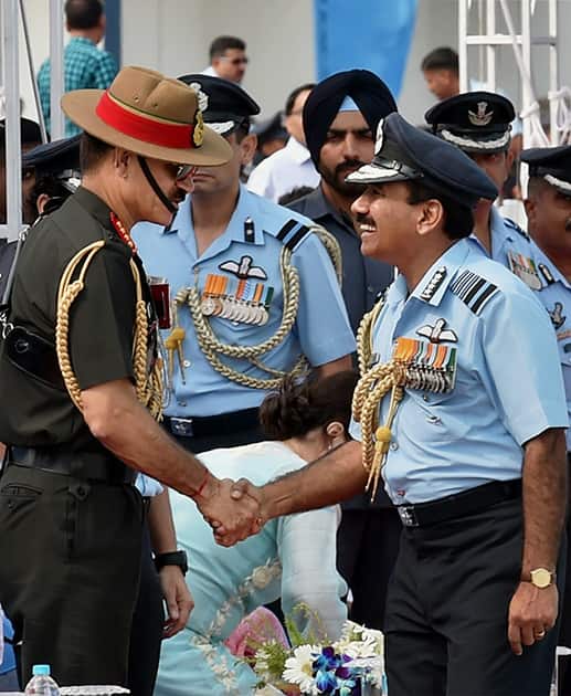 Air Chief Marshal Arup Raha shakes hands with Army chief Gen Dalbir Singh Suhag during the 82nd Air Force Day function at Air Force Station Hindon in Ghaziabad.