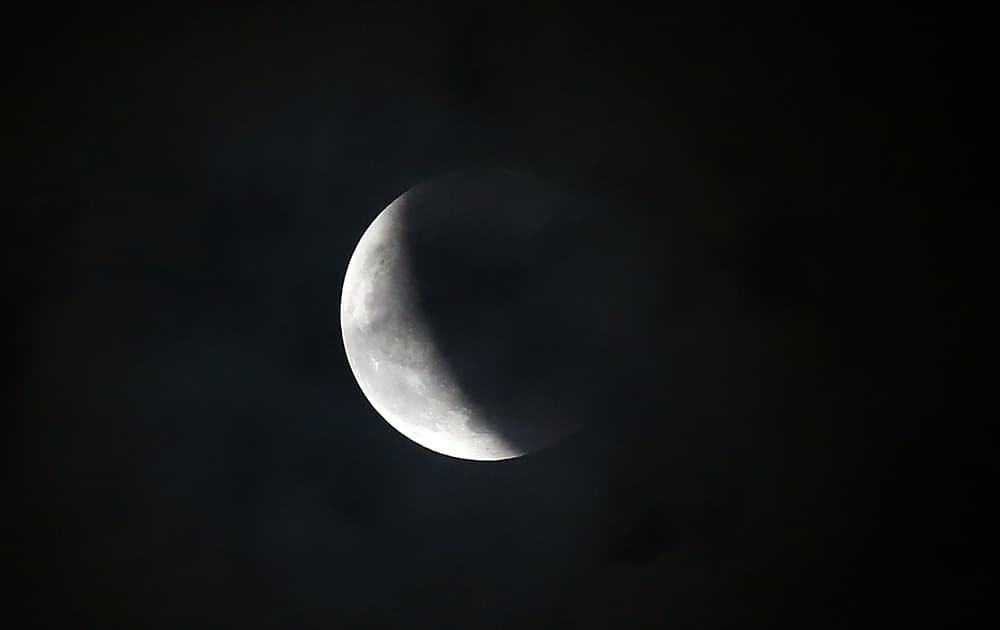 The Earth's shadow slowly passes by the moon during a total lunar eclipse from Quezon city, north of Manila, Philippines. 