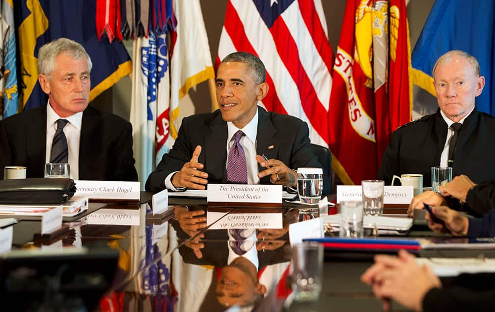 President Barack Obama, flanked by Defense Secretary Chuck Hagel, left, and Joint Chiefs Chairman Gen. Martin Dempsey, speaks to the media at the conclusion of a meeting with senior military leadership.