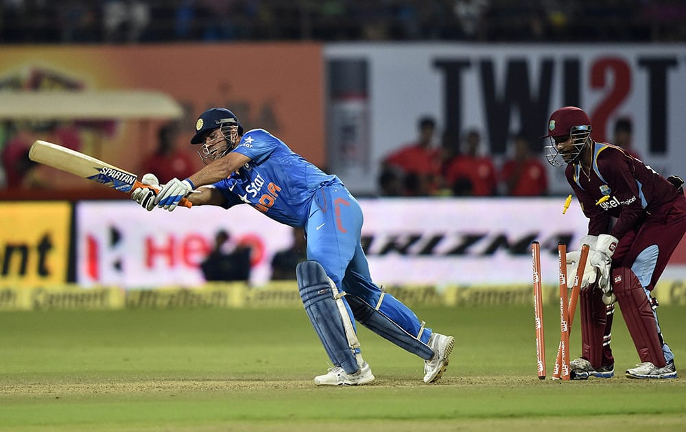 MS Dhoni is bowled out by West Indies Darren Sammy during their first ODI match at Jawaharlal Nehru Stadium in Kochi.