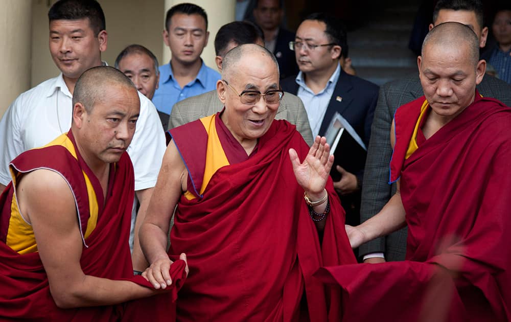 Tibetan spiritual leader the Dalai Lama, center, leaves after his religious talk at the Tsuglakhang temple in Dharmsala.