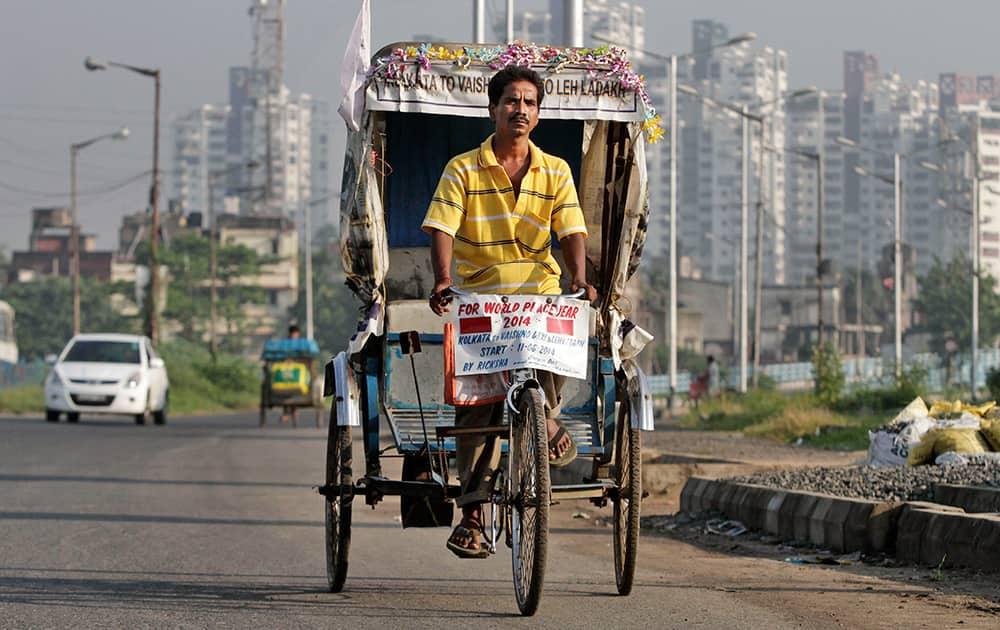 Satyen Das rides his rickshaw on a road in Kolkata. It took 68 days for Das to laboriously pedal his rickety, self-remodeled bicycle rickshaw from the seaside Indian city of Kolkata to the roof of the world - a 5,369-meter (17,600-foot) Himalayan pass. 