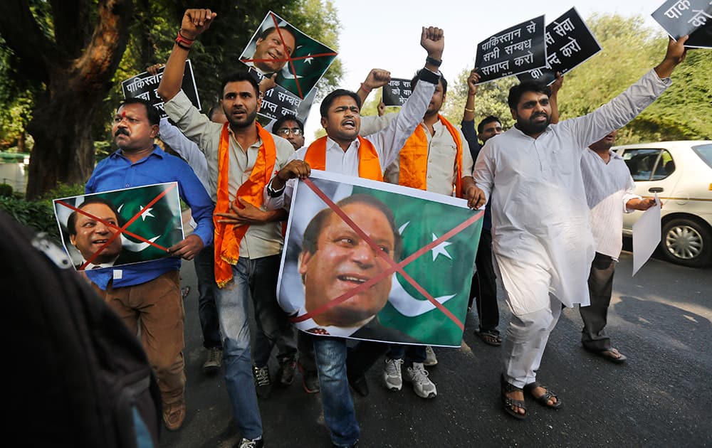 A small group of activists of the Hindu Sena carrying posters with the flag and portrait of Pakistan Prime Minister Nawaz Sharif march towards the residence of Pakistan High Commissioner to India in New Delhi.