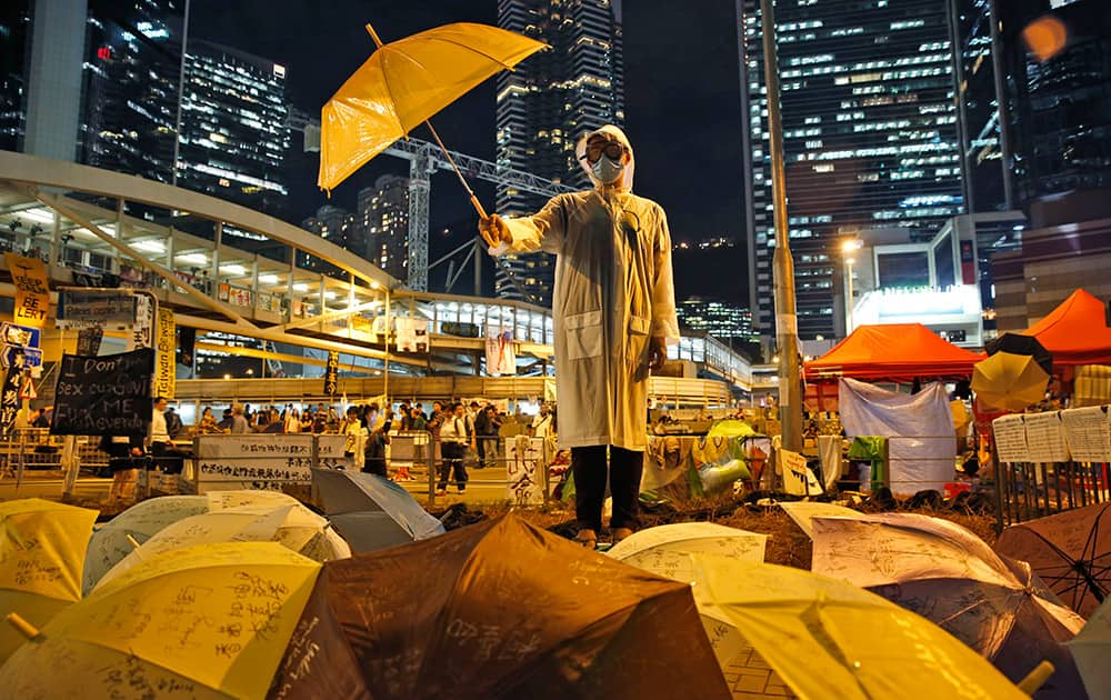 A protester holds an umbrella during a performance on a main road in the occupied areas outside government headquarters in Hong Kong's Admiralty in Hong Kong.