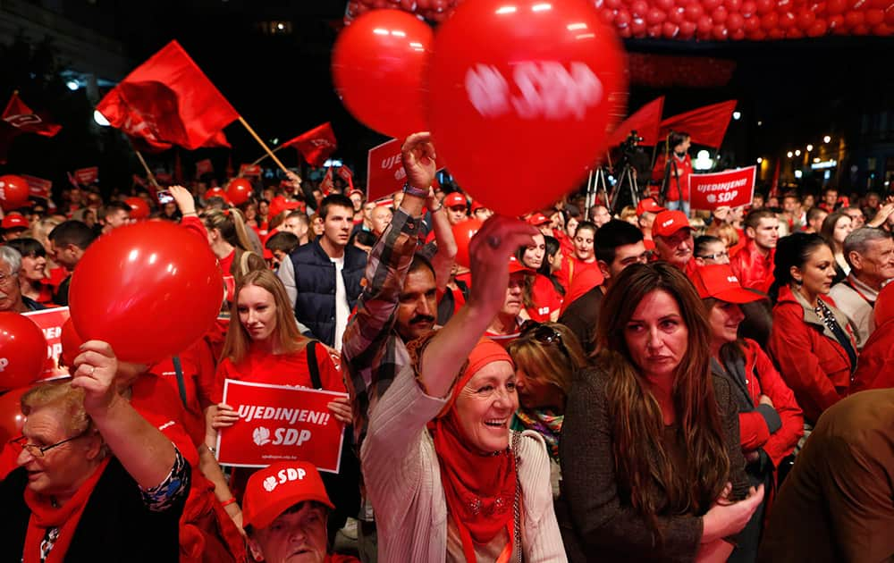 Supporters of the Social Democratic Party (SDP) wave flags and balloons during a final pre-election rally in Sarajevo, Bosnia.