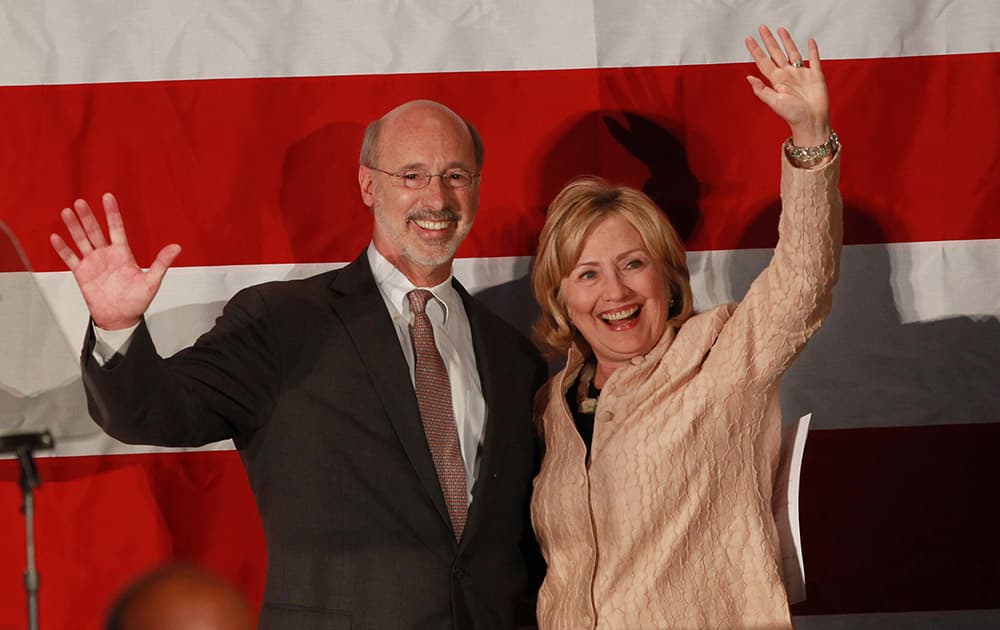 Democratic Gubernatorial candidate Tom Wolf and former Secretary of State Hillary Clinton wave to the crowd after Wolf introduced her to the crowd at the Constitution Center, in Philadelphia.