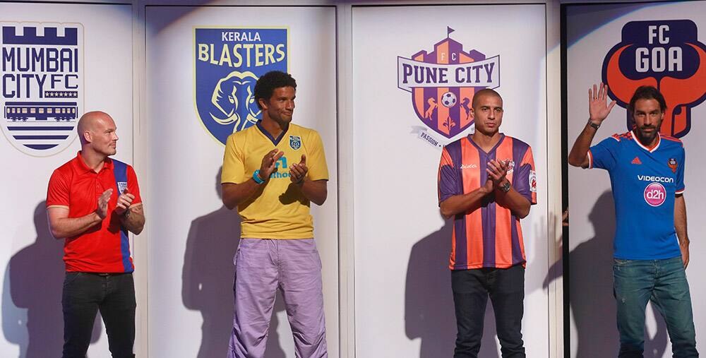 Swedish footballer Fredrik Ljungberg who will play for the Mumbai team, English footballer David James, who will play for the Kerala Blasters team, French footballer David Trezeguet, who will play for the Pune team and French footballer Robert Pires who will play for the Goa team stand during the unveiling of the trophy of the inaugural Indian Super League (ISL) in Mumbai.