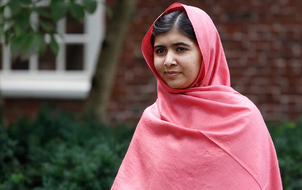File Photo: Malala Yousafzai listens as Harvard President Drew Gilpin Faust introduces her to reporters at Harvard University in Cambridge, Mass. Children's rights activists Malala Yousafzai of Pakistan and Kailash Satyarthi of India and have won the Nobel Peace Prize. 