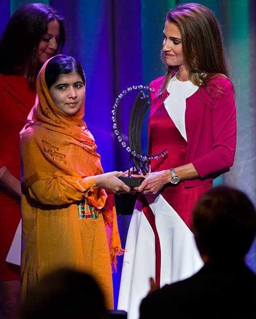 File Photo: Malala Yousafzai, the Pakistani teenager shot by the Taliban for promoting education for girls, is given the Leadership in Civil Society Award by Queen Rania of Jordan at the Clinton Global Initiative's Citizen Awards Dinner, in New York. Teenage activist Malala Yousafzai has jointly won the Nobel Peace Prize for her 'heroic struggle' for girls' rights to education, it is announced Friday Oct. 10, 2014.