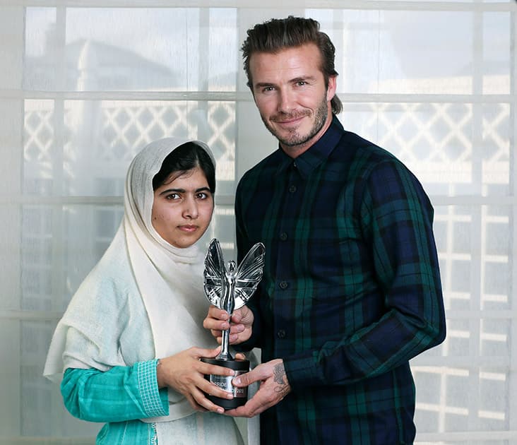 File Photo: David Beckham presents a Mirror Pride of Britain Teenager of Courage Award to Malala Yousafzai, Pakistani schoolgirl who was shot by the Taliban for going to school.