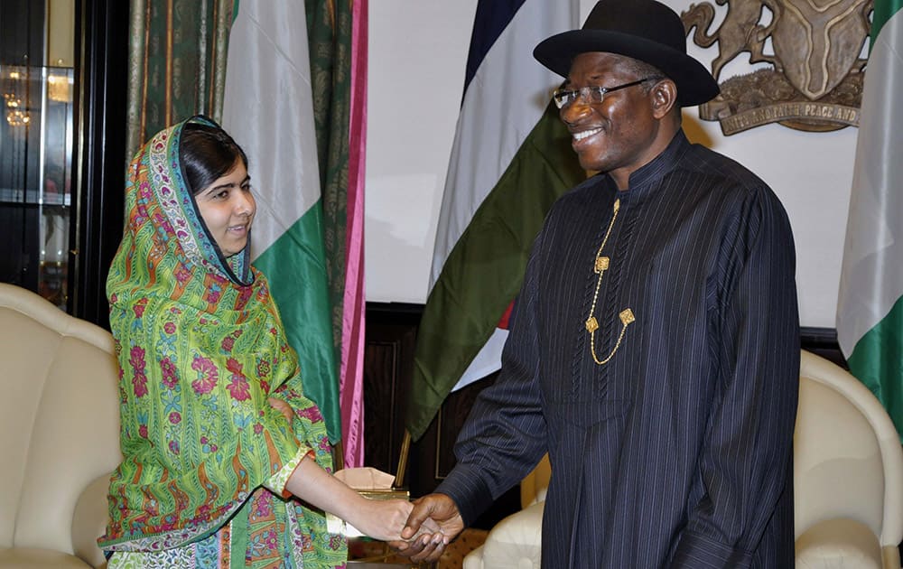 File Photo: Pakistani activist Malala Yousafzai shakes hands with Nigerian President Goodluck Jonathan, at the Presidential villa, in Abuja, Nigeria. Yousafzai on Monday won a promise from Nigeria’s leader to meet with the parents of some of the 219 schoolgirls held by Islamic extremists for three months.